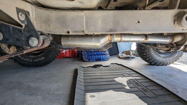 Catalytic converter sitting below the vehicle frame.