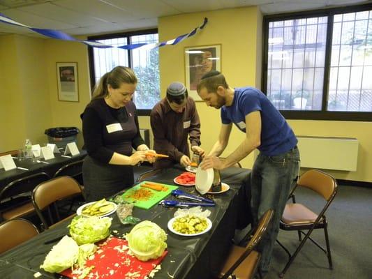 Volunteers making sandwiches for senior housing residents.