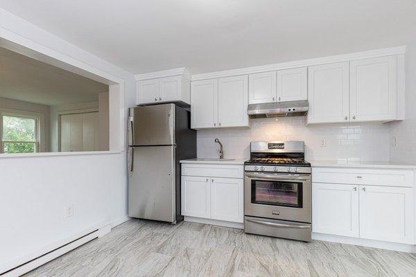 Modern white kitchen renovation with white shaker cabinets