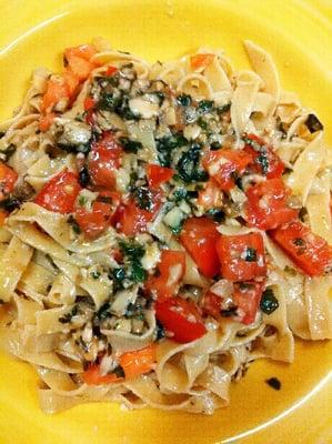 Gluten free pasta topped with dairy free/nut free/garlic free fresh basil pesto with tomatoes!