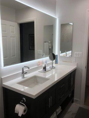 Vanity and mirror in master bath remodel.