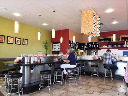 Counter seating where the plates pass by for you to grab