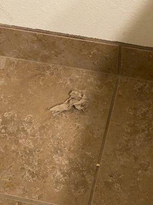 Wadded up paper towel on floor