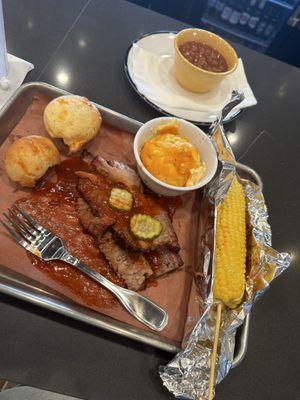 Marble brisket, mac n cheese, bake beans, and barbeque corn on the cob.