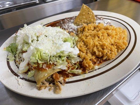 Red enchiladas combination with everything (lettuce, queso cotija, and sour cream)