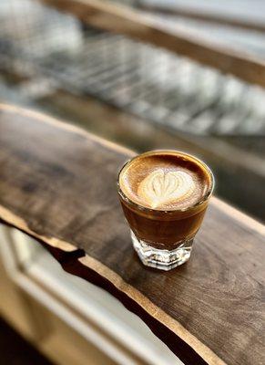 The perfect cortado on a simple bar along the window.