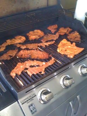 pre cooking the meats before we head out to sell the marvelous food