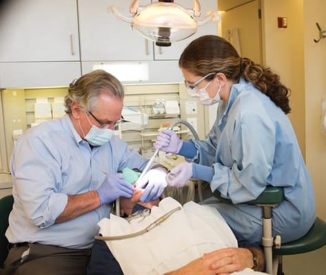 Dr. Morrison and his Assistant, Rhonda, working on a patient.