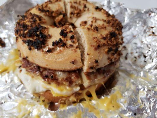 Egg, sausage and cheese breakfast bagel on a garlic bagel