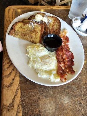 Brioche French Toast with bacon and over medium eggs