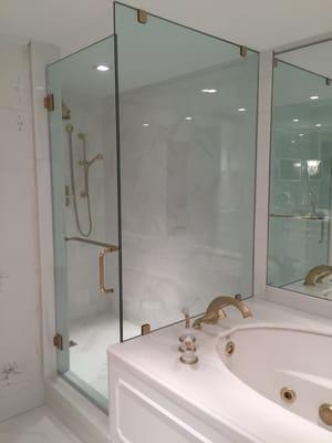 Mirrtique, Inc. Glass & Mirror Co. Furnished and installed this 1/2" clear glass 90deg. Shower with custom hardware in Trump Plaza