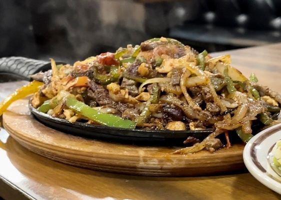 Chicken and steak fajita. Sizzling hot.