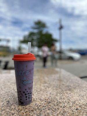 Taro milk tea (with extra boba) at an outdoor table