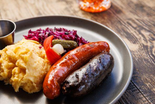 Lunch Iberian Bangers & Mash - Linguica & Merguez sausages, saffron mashed potatoes, braised red cabbage, mustard & harissa.