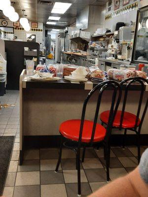 Fresh food and bread with dirty dishes piled you next to it