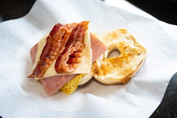 The best selling breakfast croissant - THE ULTIMATE. Available on a bagel or crossiant - egg, bacon, ham, and cheese.