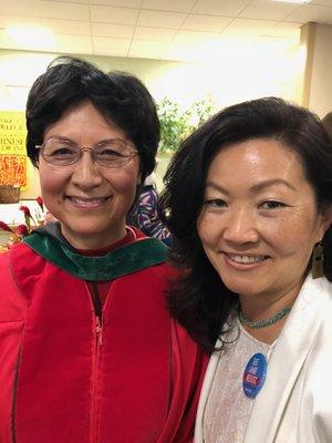 A joyful graduation day photo with the Executive Director of American College of Chinese Traditional Medicine (ACTCM) at CIIS, Lixin Huang.