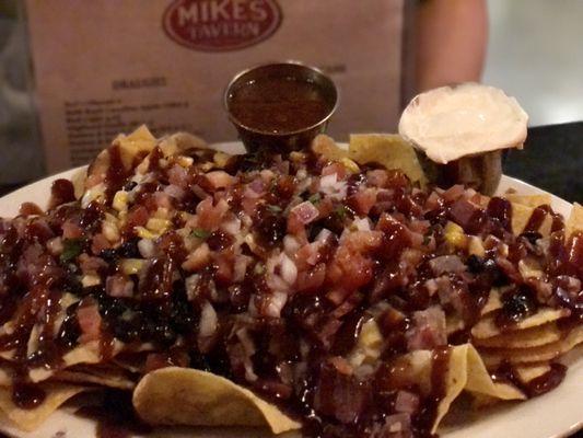 Beef brisket nachos. Sweet bbq beef on chips.  Lots of food.   Get to share.