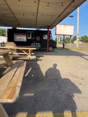 Food truck and waiting for inside to be remodeled  in the building beside it