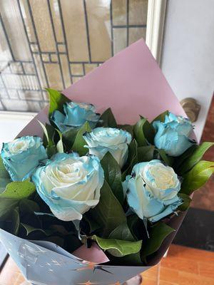 White roses sprayed with blue