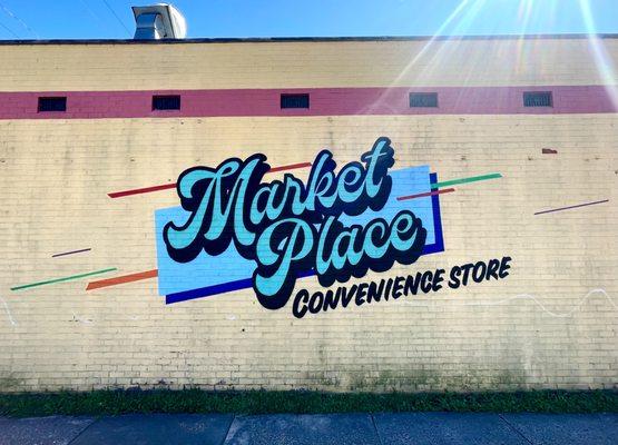 Convenience Store mural with Script and graphic design over existing wall per client's request in Highland Park in Richmond, VA