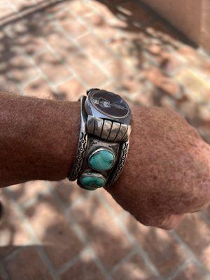 Navajo silversmith watch band with turquoise.