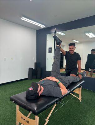 Helping Client loosen tight muscle with Assisted  Proprioceptive Neuromuscular Stretch (PNF)