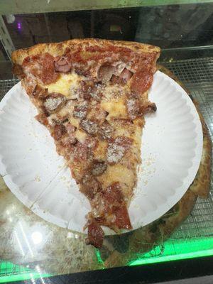 Meat lovers pizza slice