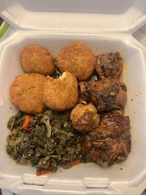 Medium brown chicken stew with Johnny cakes and callaloo