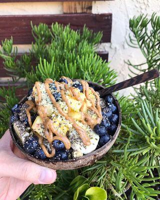 Acai bowl with fresh blueberries, banana, pineapple, almond butter, hemp seeds, and chia seeds