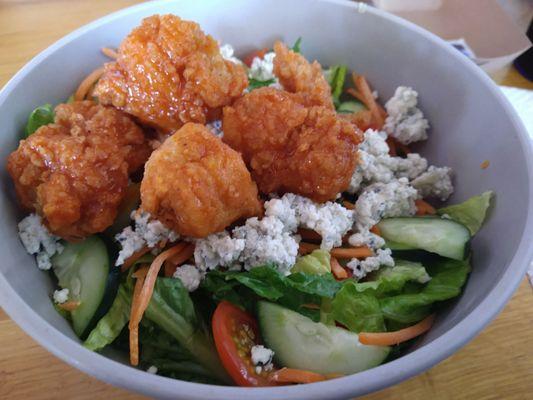 Lunch classic salad with blue cheese and boneless wings in medium buffalo sauce.