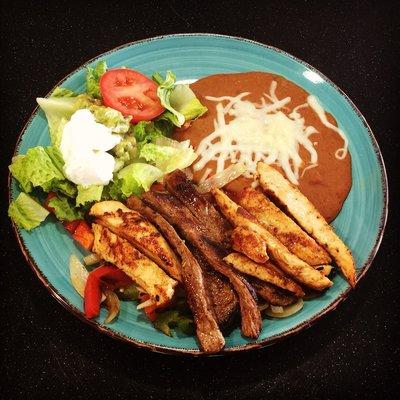 Chicken & Steak Combo Fajitas. Served with salad and beans.