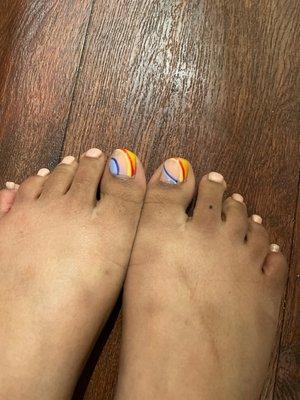 Horrible sloppy pedicure that does not even match both sides are completely different designs .