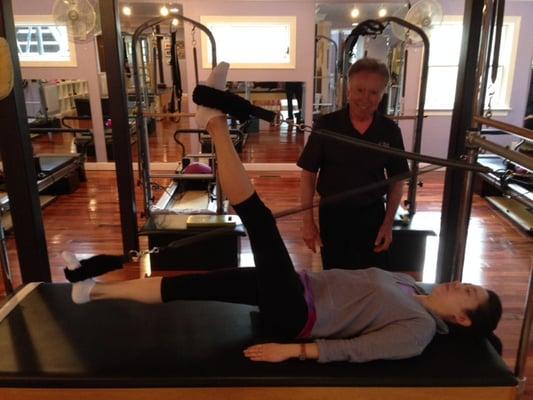 Exercising on the pilates Cadillac for back strength and muscle toning