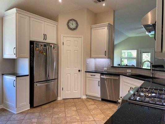 Custom side cabinets to make practical storage next the the refrigerator!