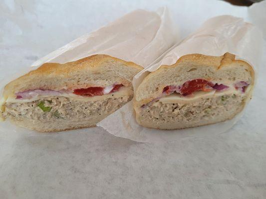 Tuna salad grinder with roasted peppers, onion, American cheese, and Mayo