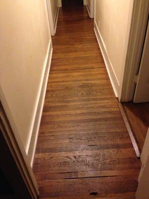 Long hallway before with more gaps and splintering