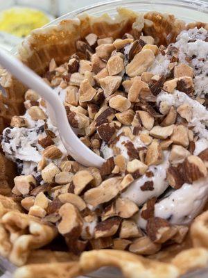 Toasted coconut ice cream with almonds in a freshly made waffle bowl