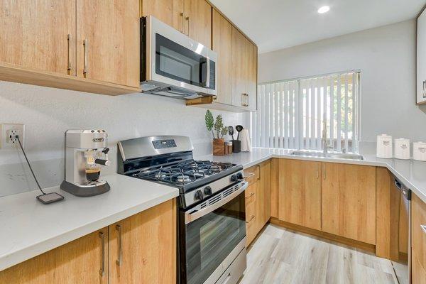 Newly renovated kitched featuring quartz countertops and farmhouse sink.