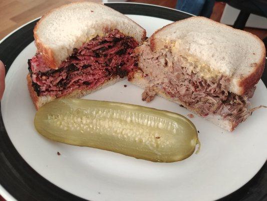 Pastrami left, brisket right. These are halves of two medium sized sandwiches on rye.