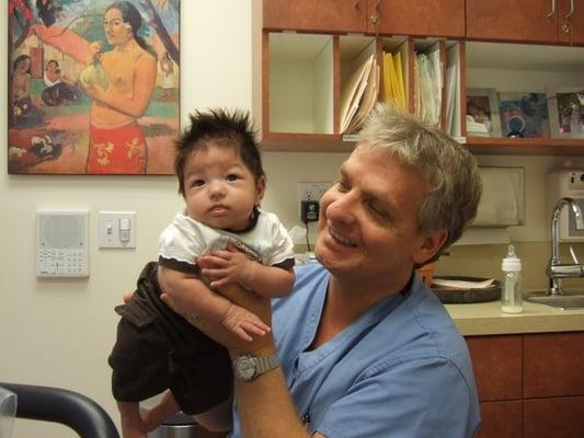 Dr. Jan Ryfors with one of thousands of babies he's delivered