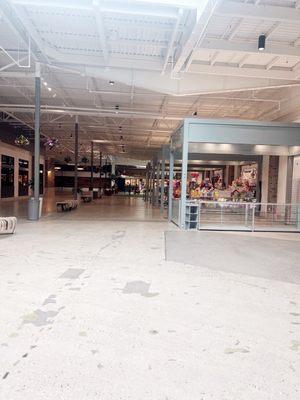 The empty hallway going towards JCPenney and through the hallway Little shop that have cute things.