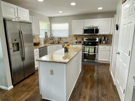 Full pic of the white cabinets they sanded and painted