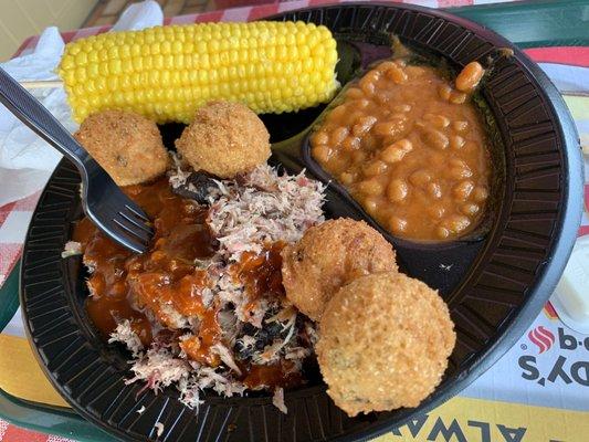 Pork dinner with corn and baked beans & hush puppies.