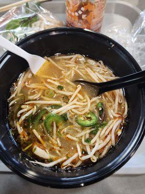 Hot and sour seafood pho (no shrimp) and a thai tea.