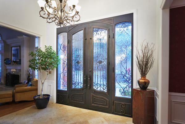 Custom designed double doors with beautiful detail and custom window paneling