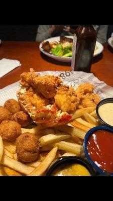 Lobster bites and shrimp bites with french fries and a garden salad and Perrier water