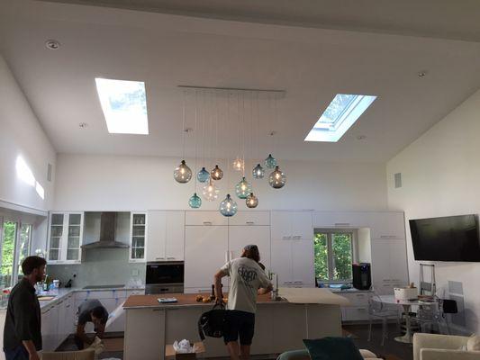 Finished product of that pendant install with each light adjusted to the exact heights the homeowner and designer requested