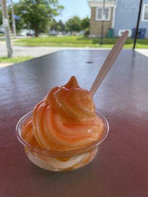 Tangerine ice on top and vanilla soft serve on the bottom