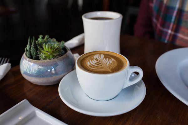 Cappuccino with a Columbia drip coffee. Each table also had succulents for sale at the time we visited.